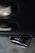 Close-up of a shiny custom car exhaust pipe installed on a sleek vehicle under soft lighting.