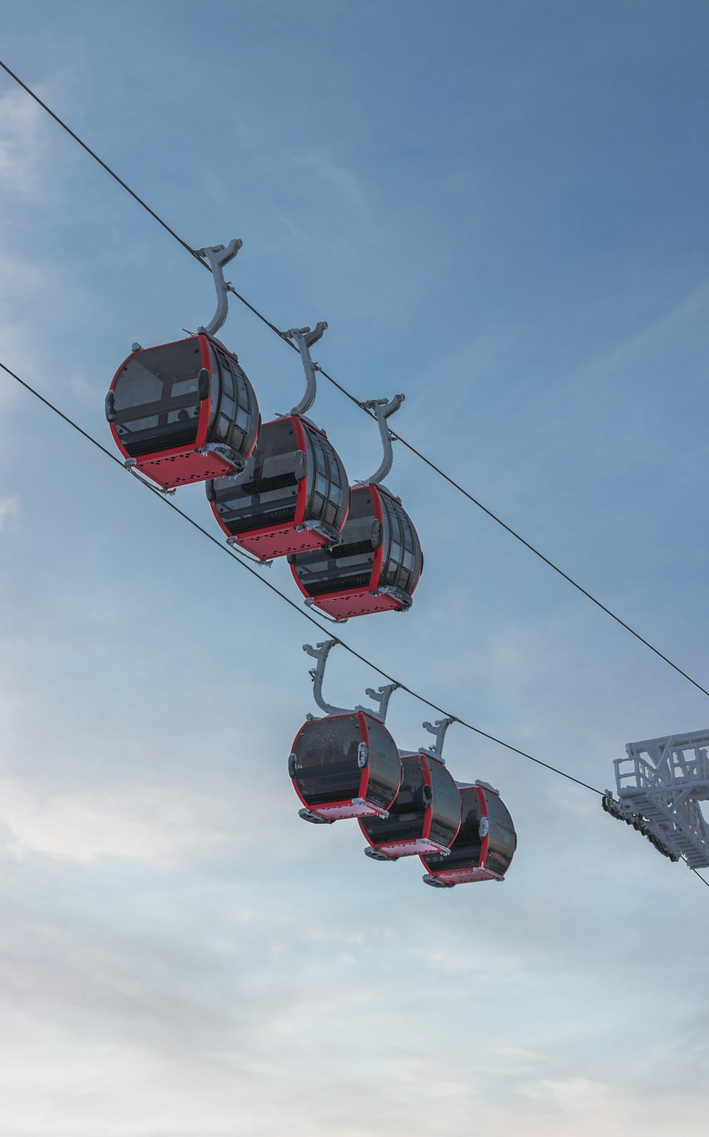 red and black cable cars under blue sky