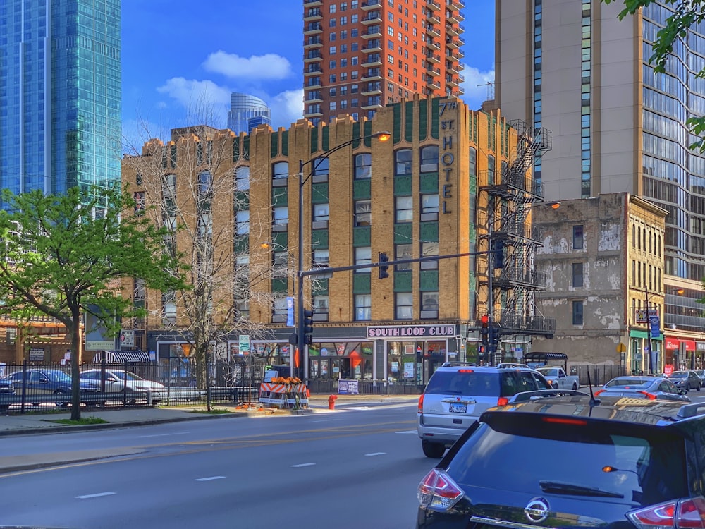 cars on road near high rise buildings during daytime