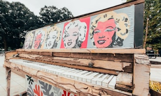 white and red graffiti on brown wooden fence