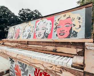 white and red graffiti on brown wooden fence