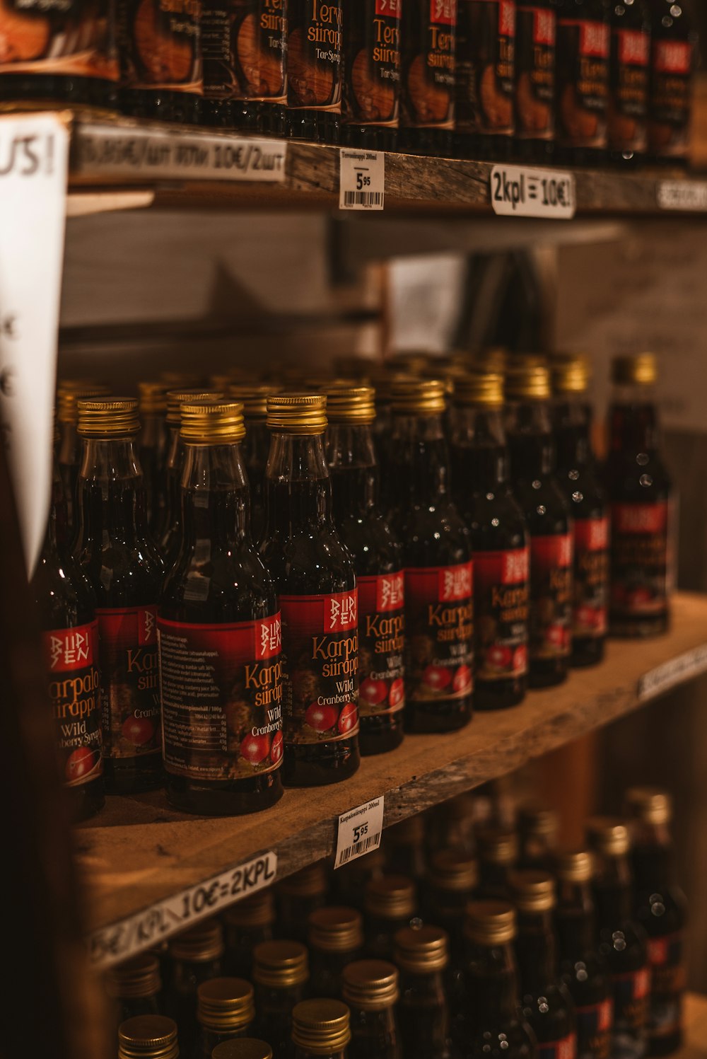 brown glass bottles on brown wooden shelf