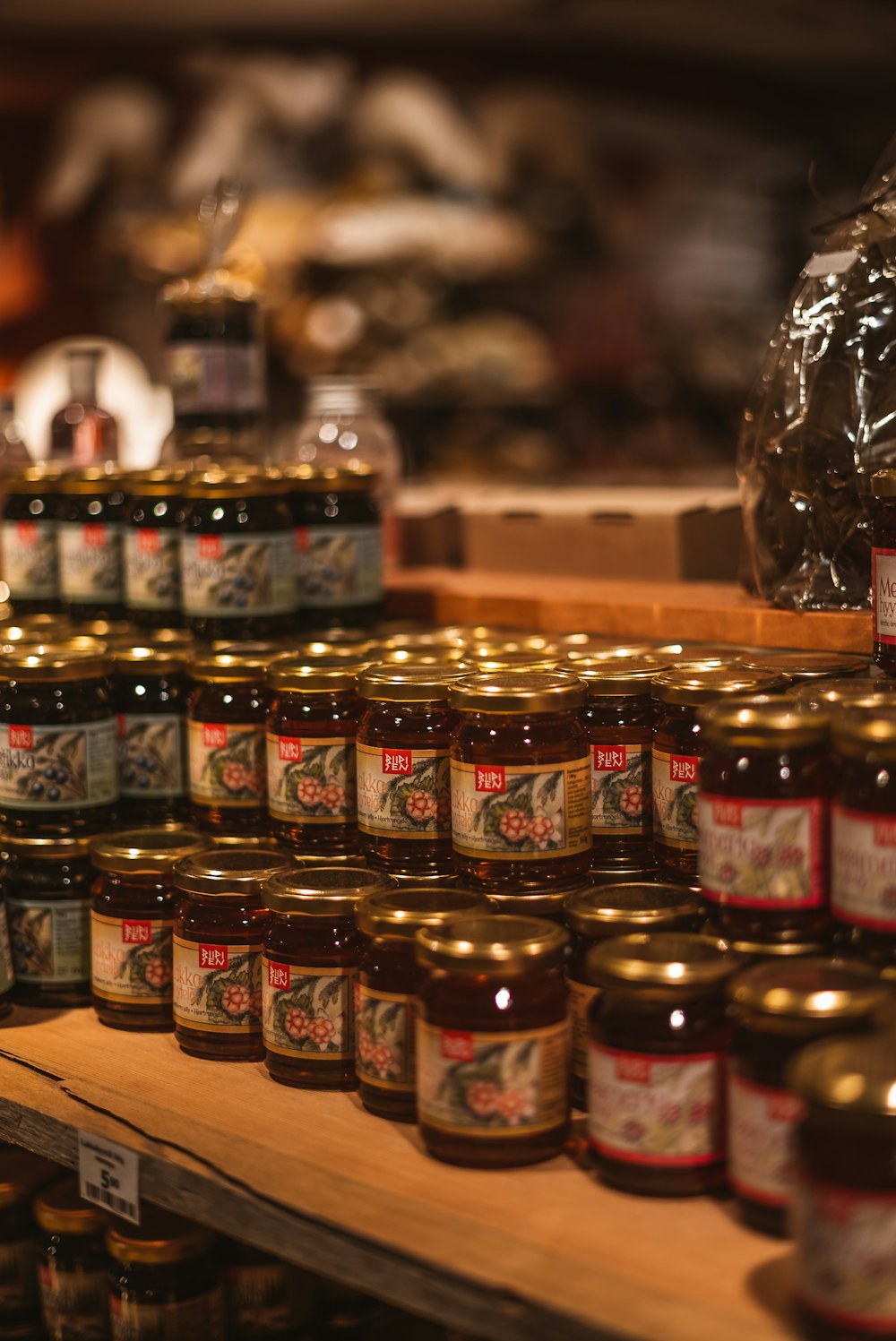 red and yellow glass jars on brown wooden table