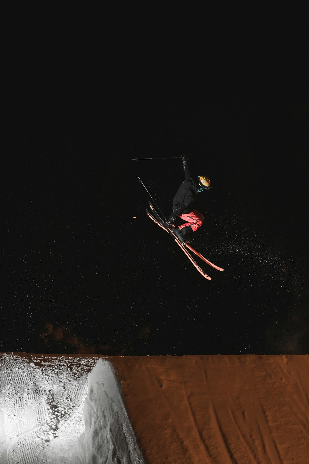 man in black jacket and black pants riding on snowboard during daytime