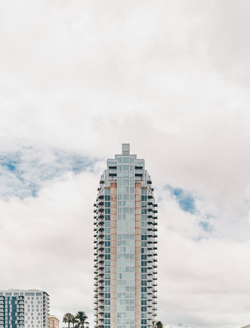 white and blue concrete building under white clouds during daytime