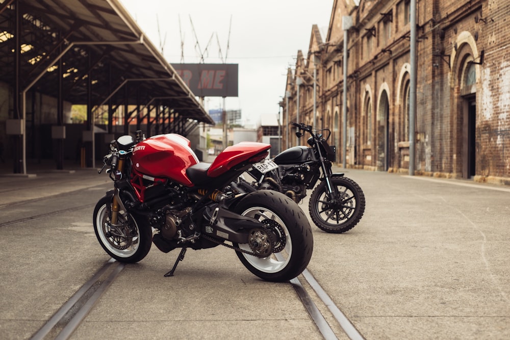 two motorcycles parked next to each other in front of a building