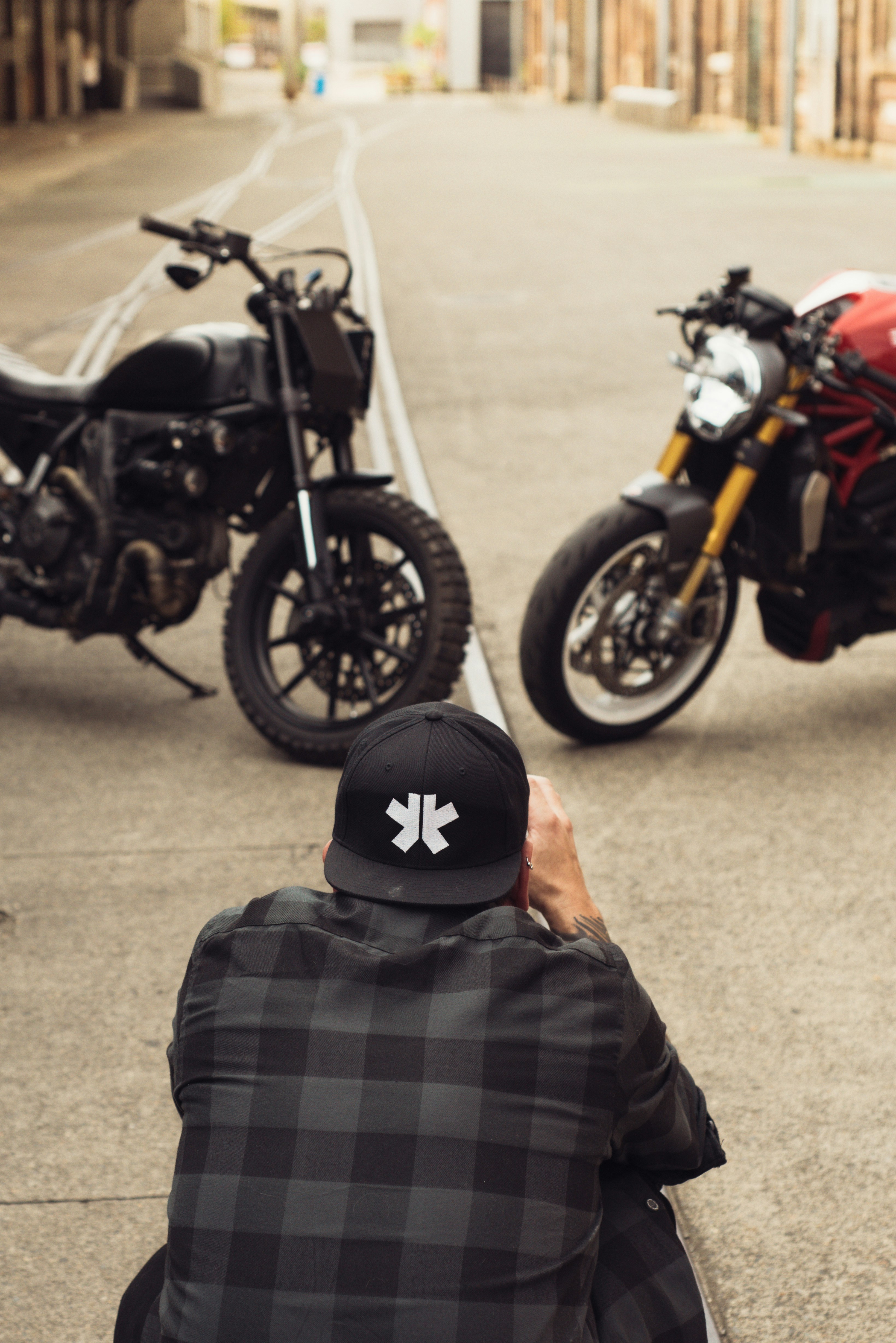 a man taking a picture of two motorcycles