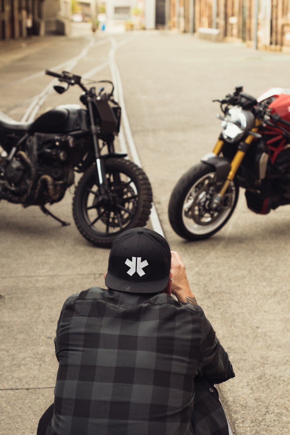 a man taking a picture of two motorcycles