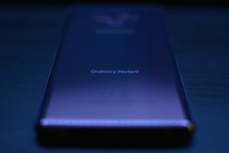 blue lenovo laptop computer on black table