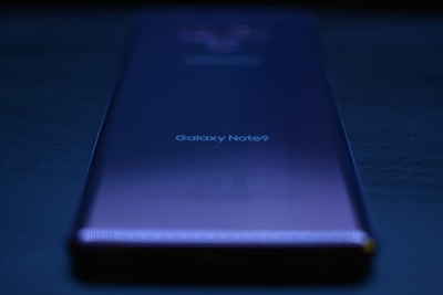 blue lenovo laptop computer on black table