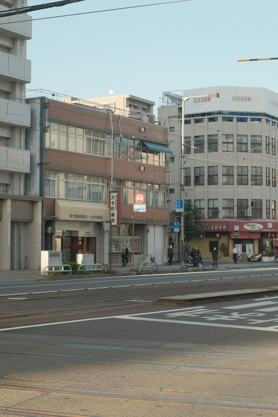 people walking on sidewalk near building during daytime