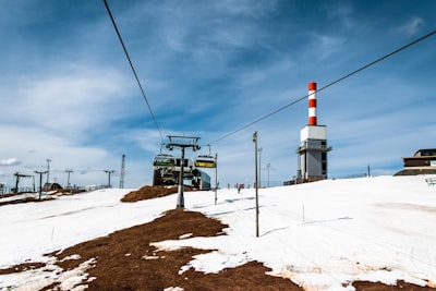 white and red tower on brown soil under white clouds during daytime splendid zoom background