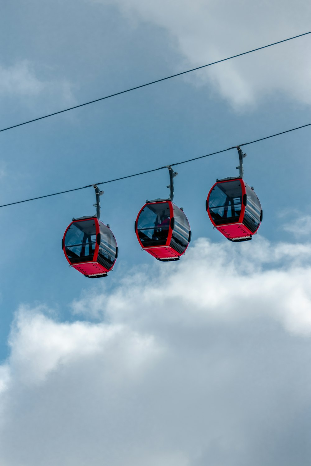 red cable car under cloudy sky during daytime