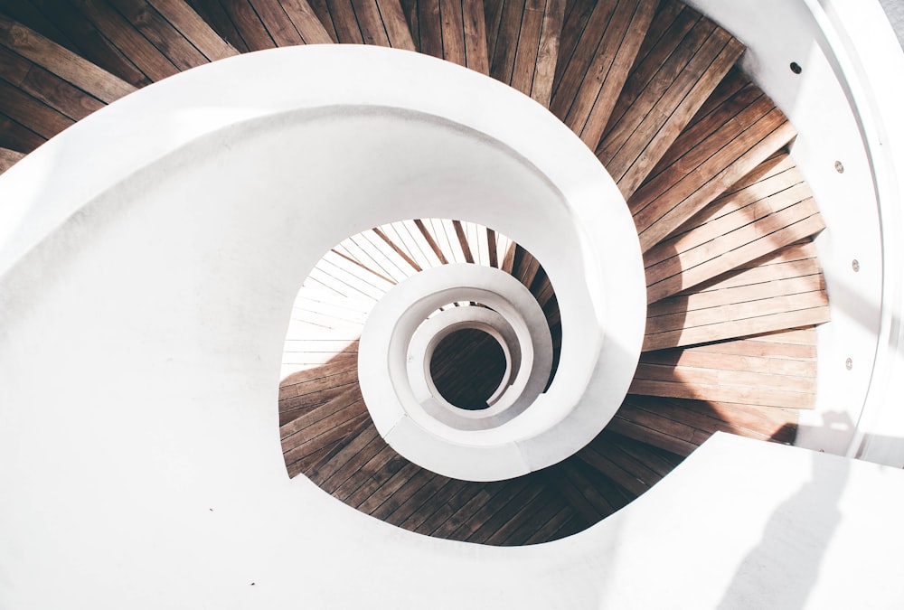 brown wooden spiral staircase with white round ceiling