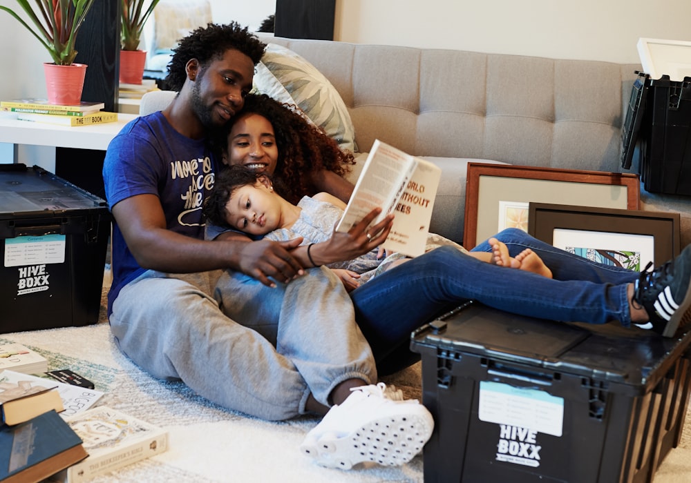 man in blue crew neck t-shirt and blue denim jeans lying on brown sofa