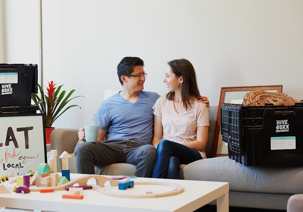 man and woman sitting on couch