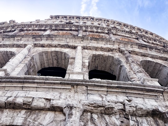brown concrete building under blue sky during daytime in Colosseum Italy