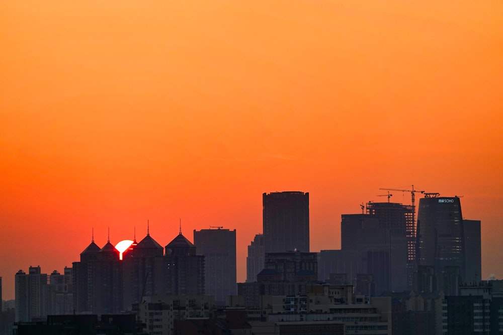 silhouette of city buildings during sunset