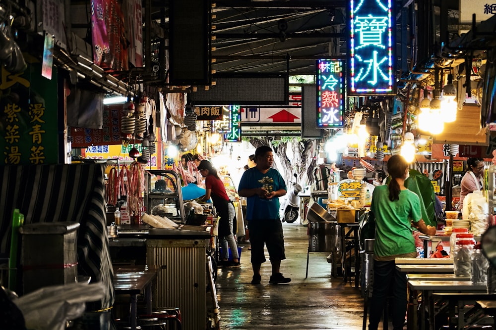 people standing in front of food stall during nighttime