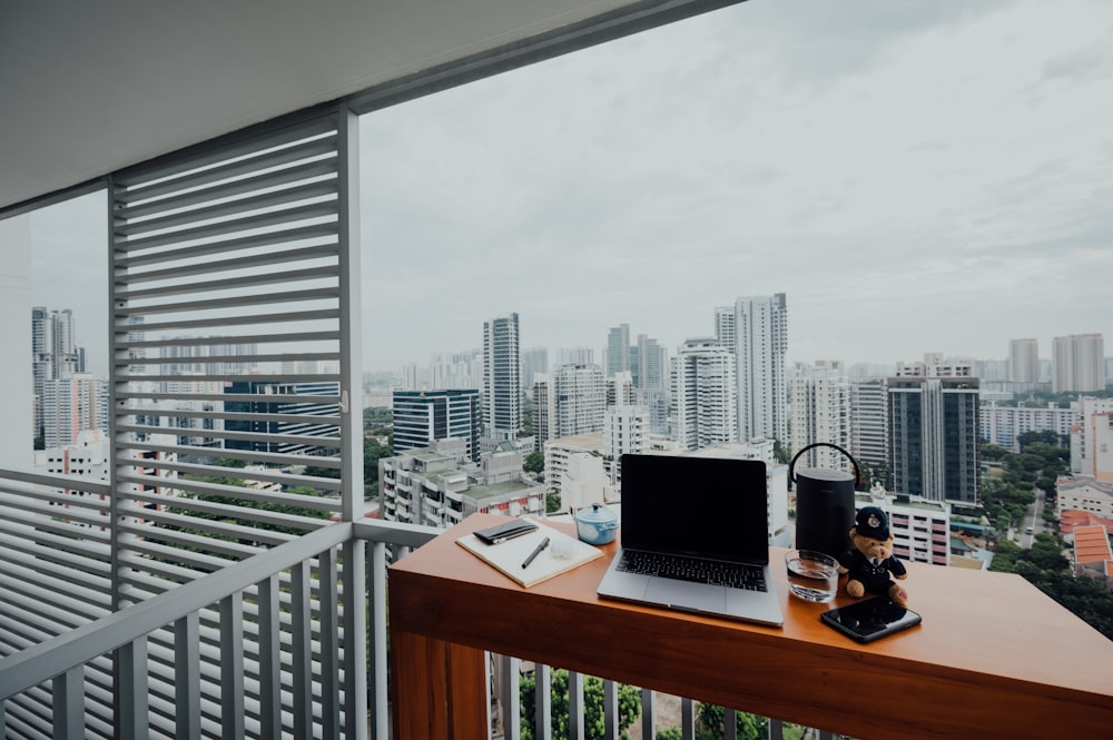 black laptop computer on brown wooden desk