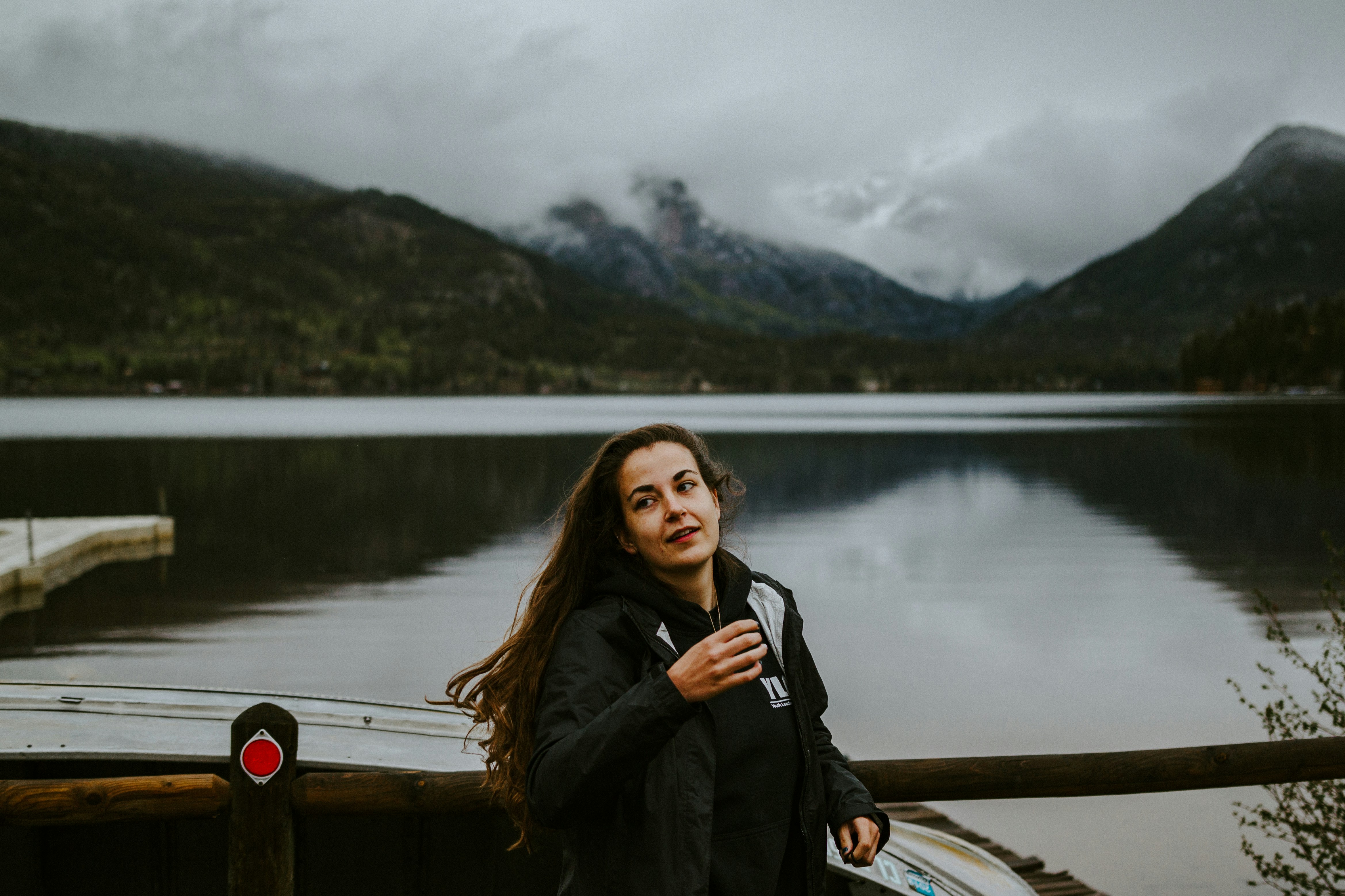 Woman in black coat standing on dock during daytime photo – Free Human ...