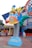 A whimsical theme park ride featuring characters resembling a cartoon family sitting in a vibrant car atop a spring-like pedestal. The ride is surrounded by colorful signage and decorative elements, with people in the background.