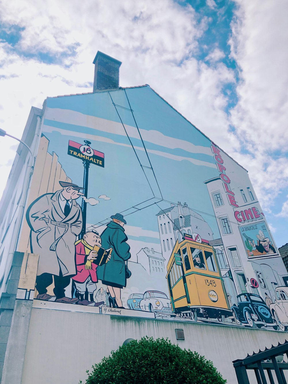 man and woman standing on top of building painting