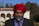 man in black suit jacket and red knit cap