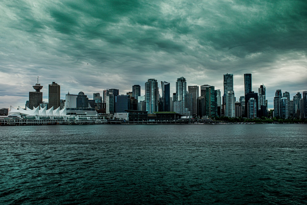 city skyline across body of water during daytime