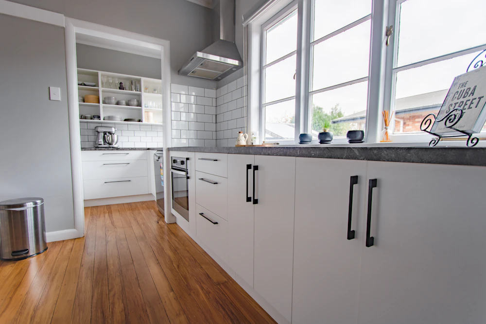 Bright white kitchen beside a window