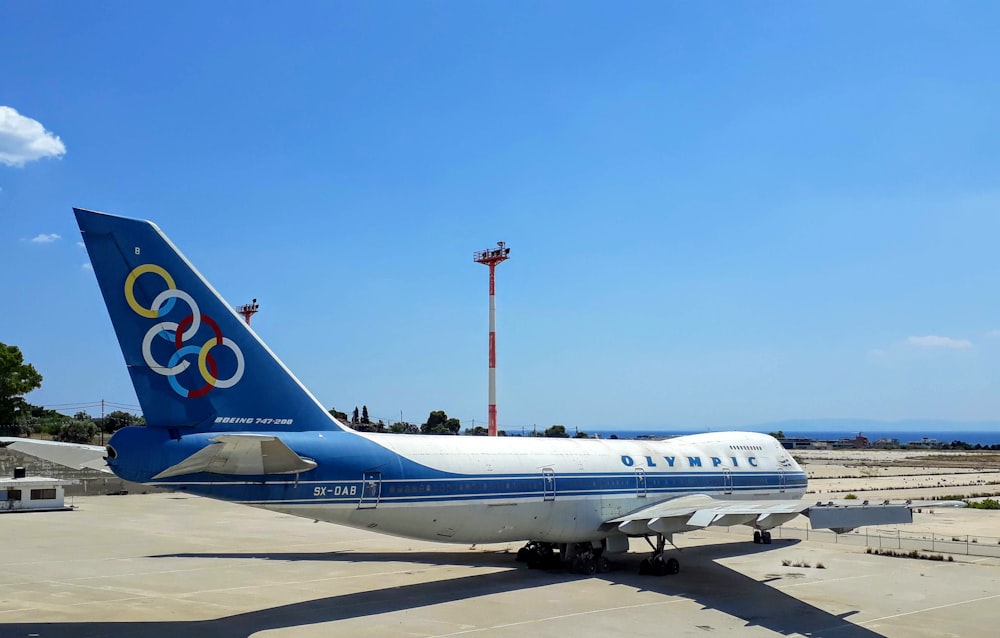 white and blue passenger plane on airport during daytime