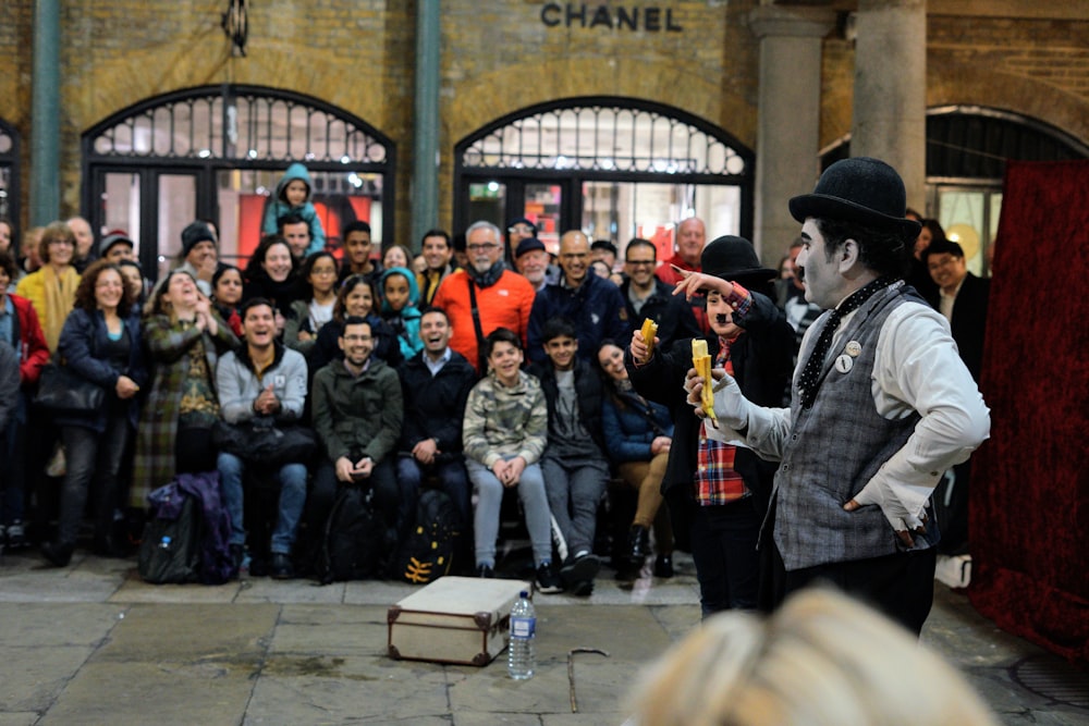 people standing and sitting on the street during daytime