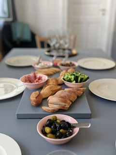 A table set with dishes featuring olive-based products.