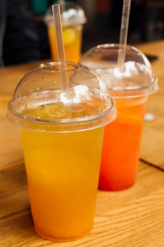 clear plastic cup with yellow liquid