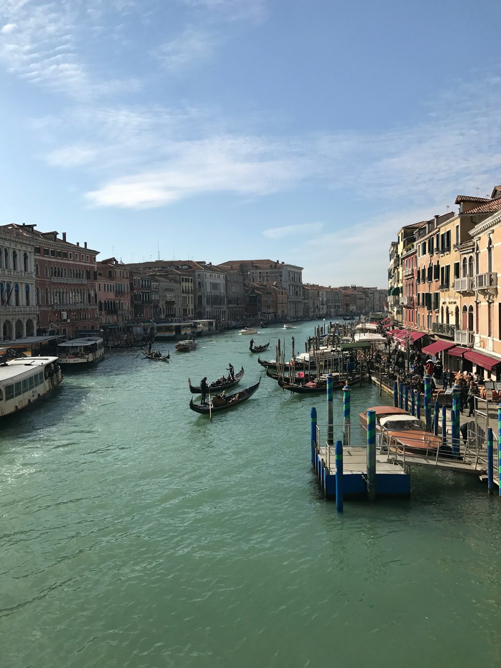 boat on water between buildings during daytime