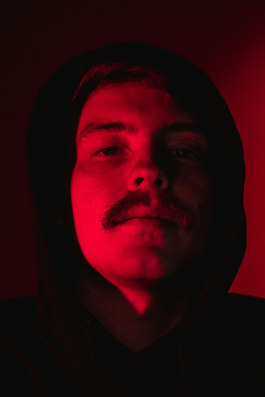 man in black hoodie with red light
