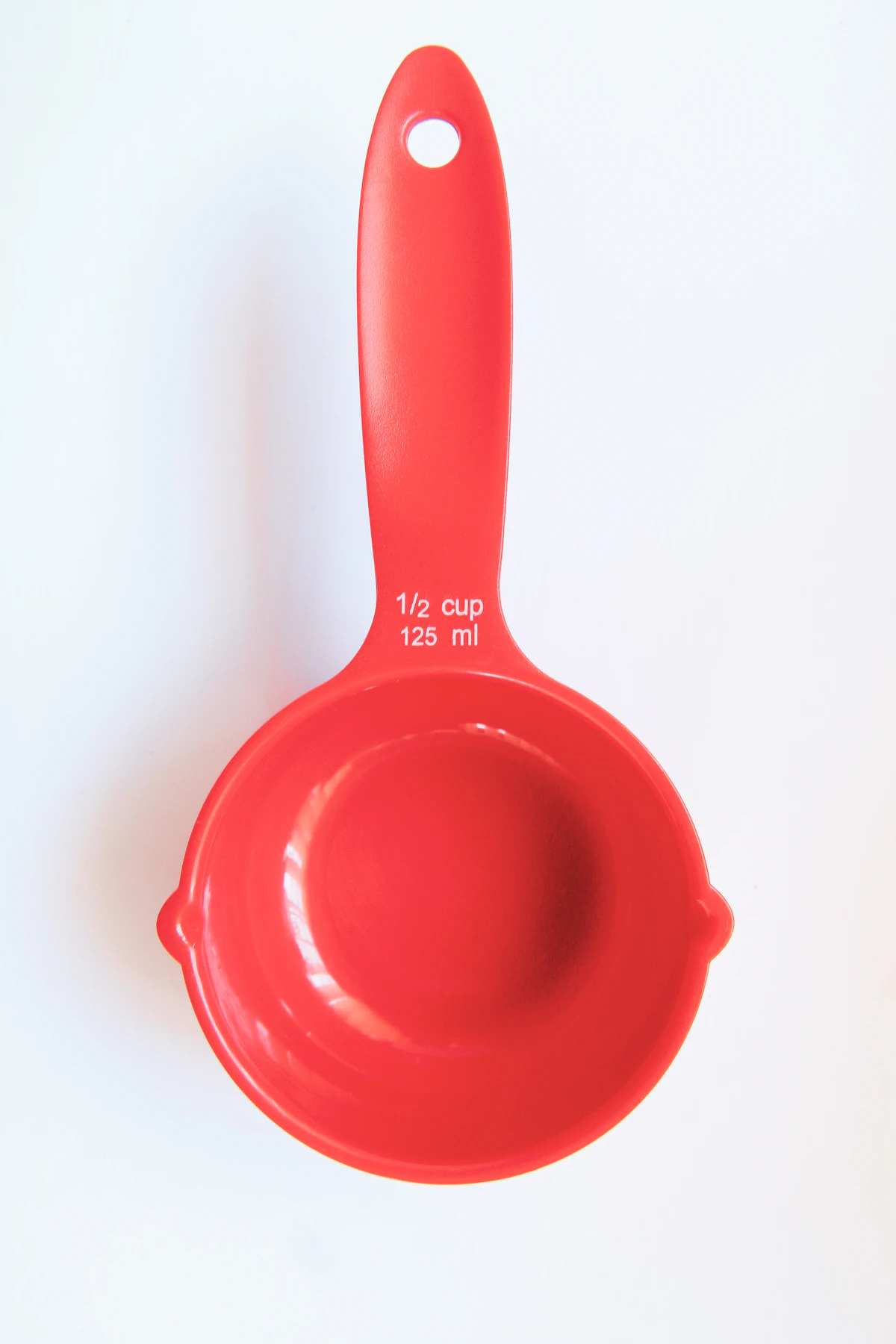 Vaso medidor rojo de plástico