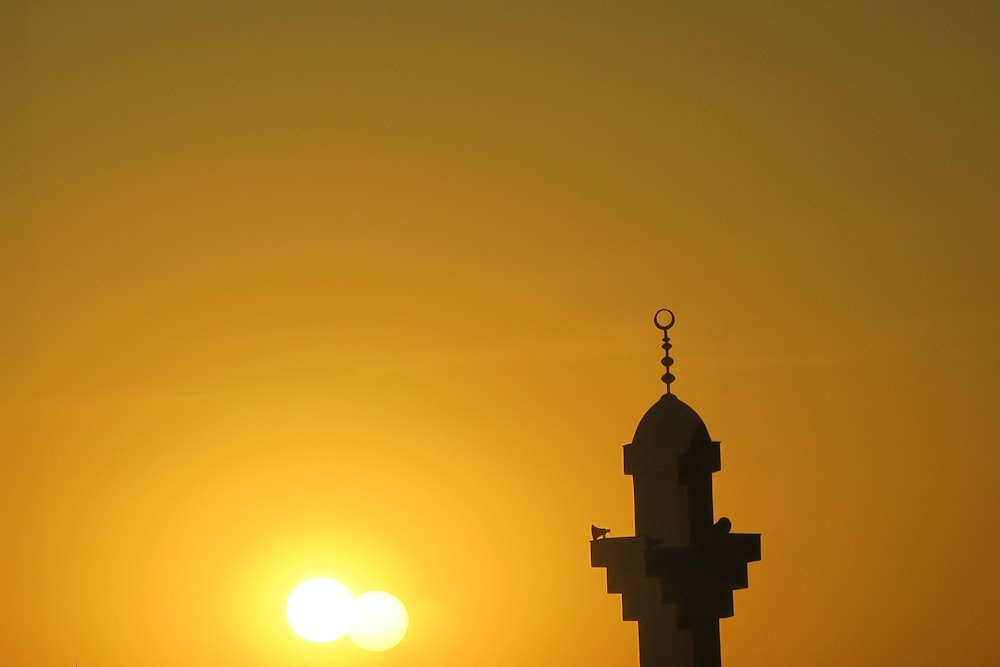 silhouette of tower during sunset