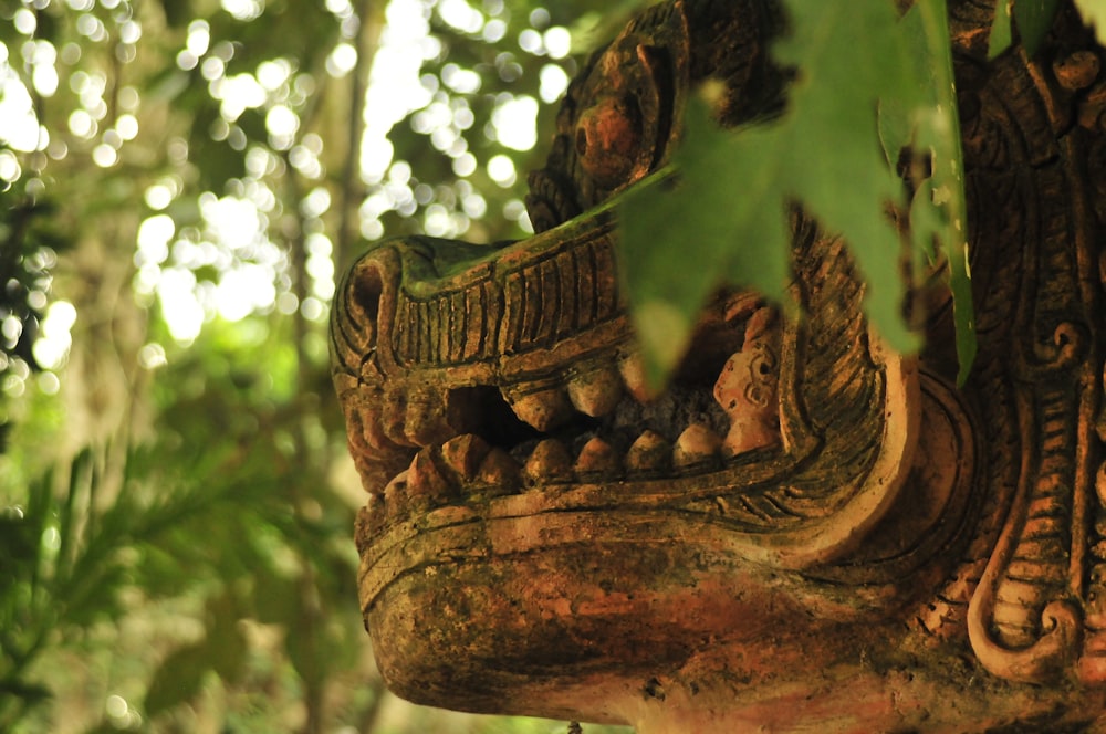 brown wooden human face carved ornament