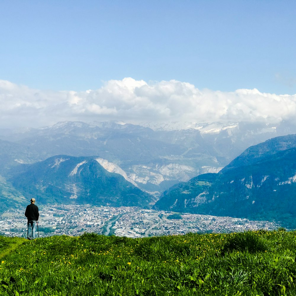 person walking on green grass field during daytime