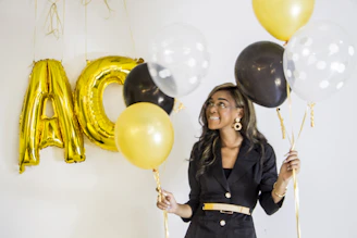 woman in black leather jacket holding balloons
