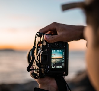 person holding black dslr camera