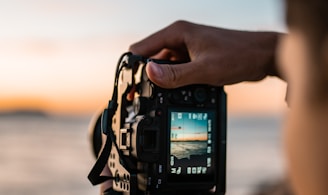 person holding black dslr camera