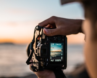 person holding black dslr camera