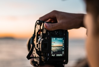 person holding black dslr camera