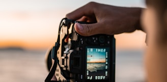 person holding black dslr camera