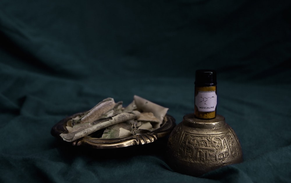 gold and black bottle on gold round tray