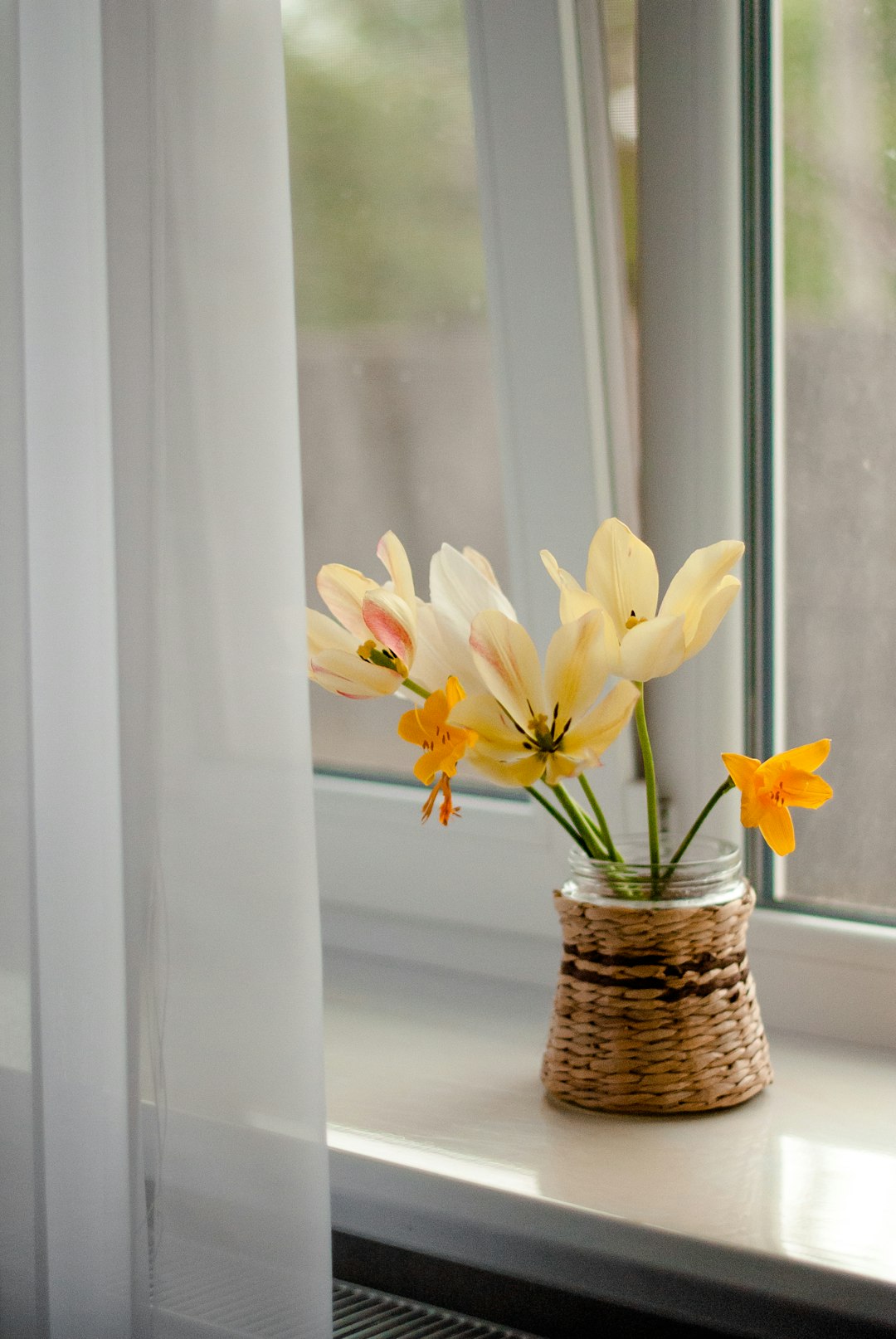 yellow and white flowers in brown woven basket