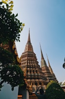 Wide shot capturing the temple's towering spires against a clear blue sky.