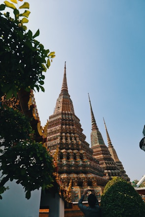 Wide shot capturing the temple's towering spires against a clear blue sky.
